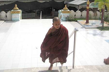 A boy monk walks from communal quarters to a shrine at the Shwe Bohmyint Pagoda, a Buddhist temple in the hills above Myawaddy, a town in the east of the country formerly known as Burma.